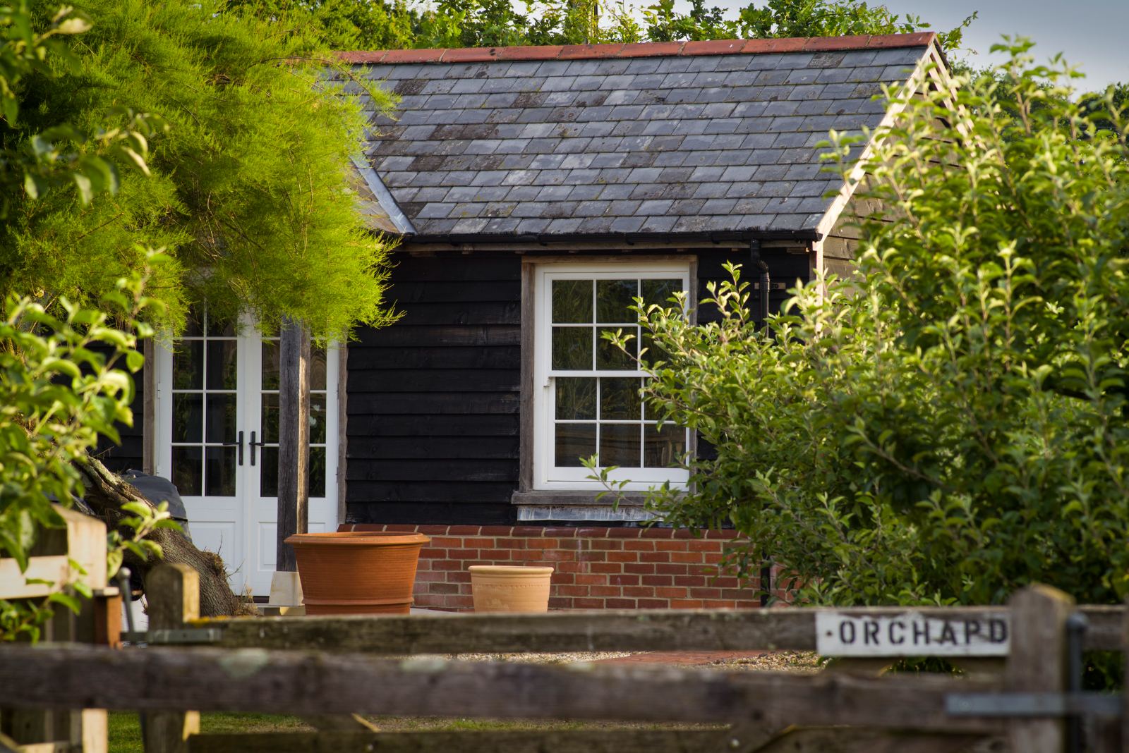 A black timber garden outbuilding